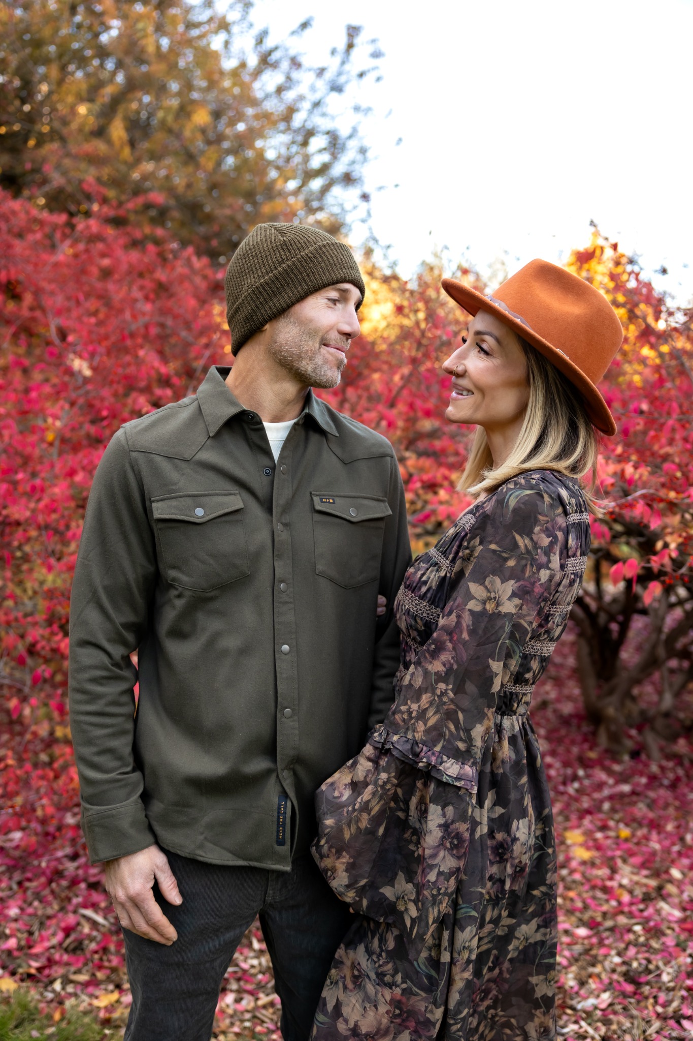 Travis and Kolbie together outdoors among autumn leaves